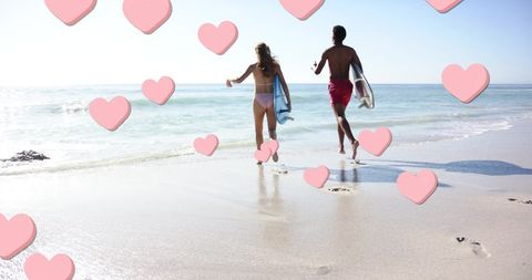 Romantic Couple with Surfboards Running on Sunny Beach