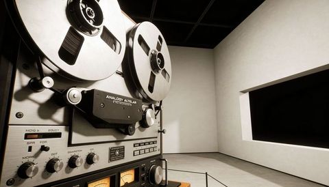 Vintage reel-to-reel tape recorder in minimalist gallery showcasing analog audio design