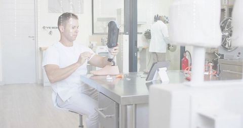 Prosthetist adjusting prosthetic foot and socket at clinic workbench for rehabilitation