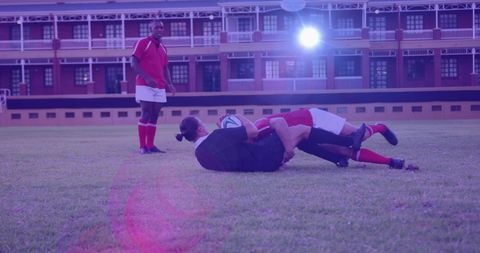 Rugby players engaging in competitive game in stadium