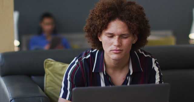 Young Man with Afro Hair Using Laptop at Home - Download Free Stock Images Pikwizard.com