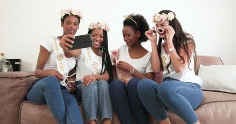 Friends celebrating bachelorette party taking selfie together