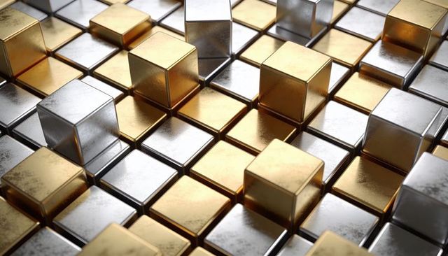 Reflective gold and silver cubes on geometric metal grid showing worn scratch texture