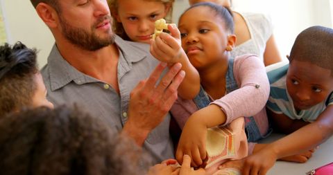 Engaged school children learning anatomy with teacher