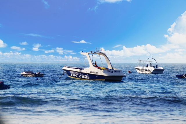 Boats Anchored in Clear Blue Ocean Under Bright Sky - Download Free Stock Photos Pikwizard.com