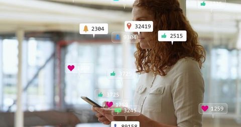 Redhead Woman Checking Smartphone with Social Media Notifications in Modern Office
