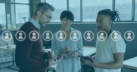 Collaborative team using tablets in modern open office with digital profile icons overlay