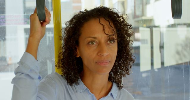 Pensive Woman Holding Onto Bus Handle During Commute - Download Free Stock Images Pikwizard.com