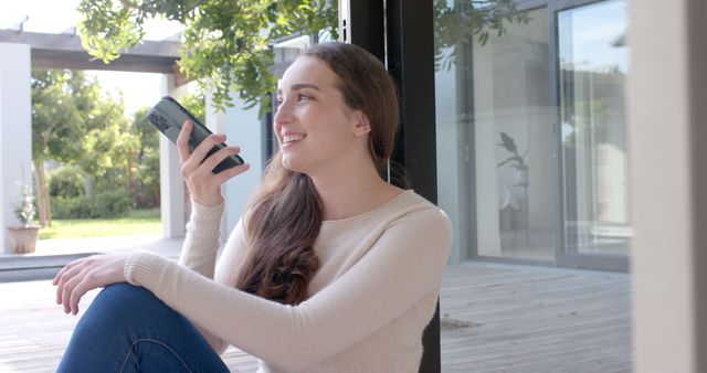 Smiling Woman Using Smartphone for Voice Message at Home - Download Free Stock Images Pikwizard.com