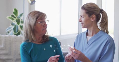 Compassionate Caregiver Assisting Woman with Medication Guidance