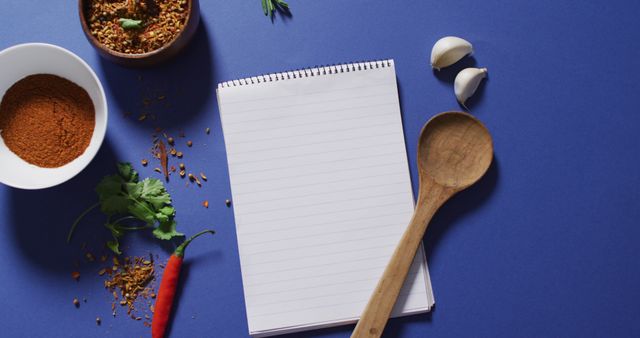 Image of notepad with copy space, spoon and seasoning lying on violet background - Download Free Stock Photos Pikwizard.com
