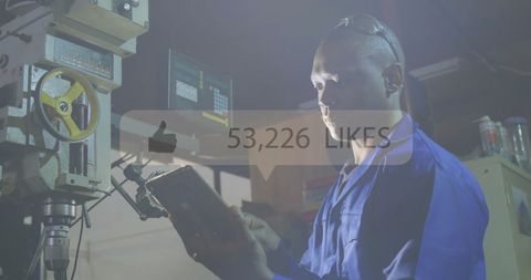 Factory worker using tablet for automation in industrial setting