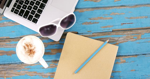 Creative Workstation with Coffee, Notebook, and Laptop on Rustic Blue Wood - Download Free Stock Images Pikwizard.com