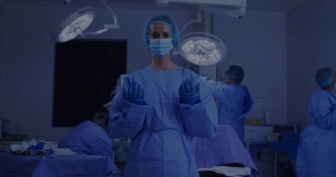 Surgeon Preparing with Team in Operating Room for Surgery