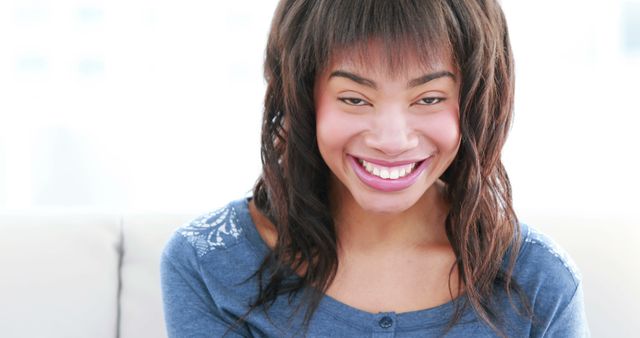 Smiling Young Woman with Natural Hairstyle Relaxing at Home - Download Free Stock Images Pikwizard.com