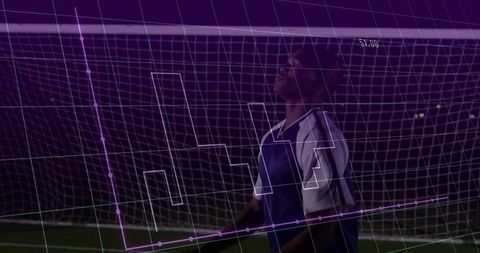 Soccer Player Analyzing Performance Data at Night
