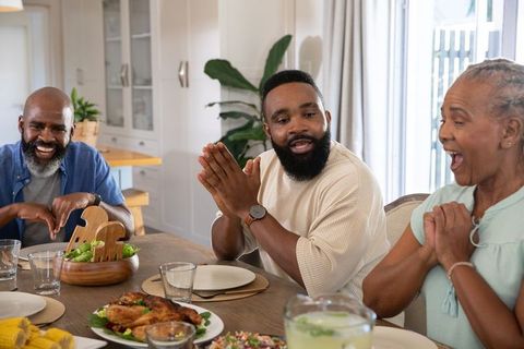 Family Gathering Enjoying Meal in Domestic Kitchen Space