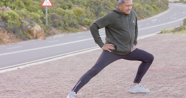 Older Man Stretching Outdoor Preparing for Exercise on a Scenic Roadside - Download Free Stock Images Pikwizard.com