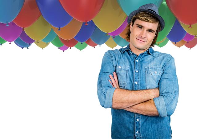 Digital composite of Trendy man with arms folded in front of balloons and white space