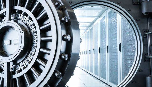 Massive vault door opening revealing secure data center server racks with blue lighting