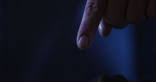 Close-up of Finger Pointing in Dark Room with Subtle Blue Light - Download Free Stock Images Pikwizard.com