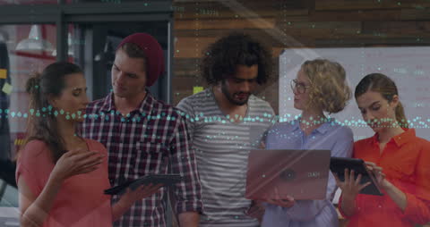 Diverse Team Analyzing Data on Digital Devices