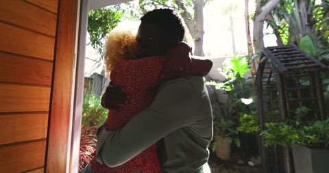 Friends Embrace on Sunny Day with Gifts and Joyful Smiles