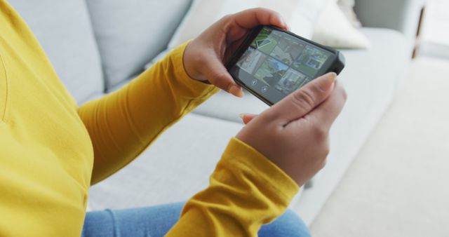 Person Playing Mobile Game on Smartphone in Living Room - Download Free Stock Images Pikwizard.com