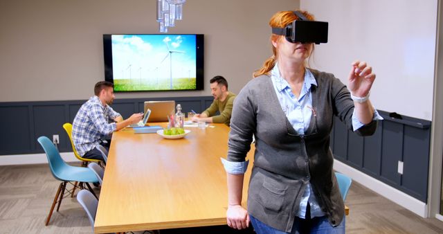 Woman Experiencing Virtual Reality in Modern Office Meeting - Download Free Stock Images Pikwizard.com