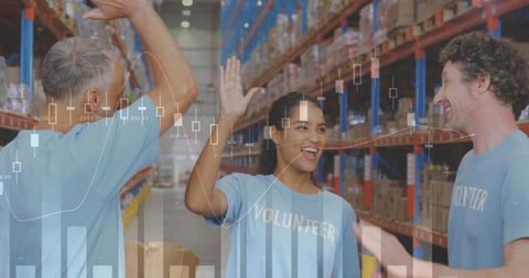 Smiling Volunteers in Warehouse with Overlayed Financial Graphs