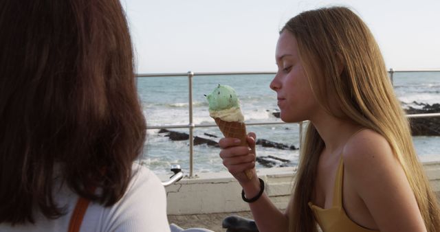 Young Women Enjoying Ice Cream by Ocean View - Download Free Stock Images Pikwizard.com