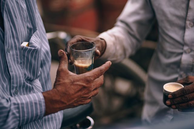 Close-up of Men Sharing Traditional Indian Chai Tea in Glass Cups - Download Free Stock Images Pikwizard.com