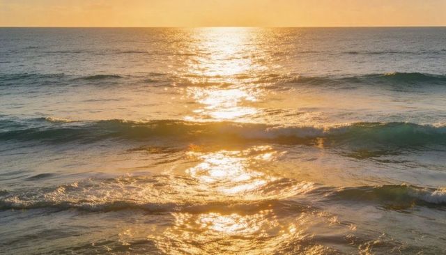 Golden sunlight glimmering on ocean waves at sunset, calm seascape glow