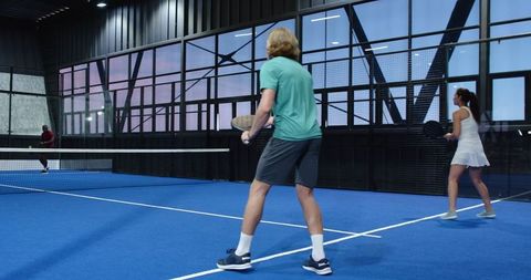 Dynamic padel match inside modern indoor court