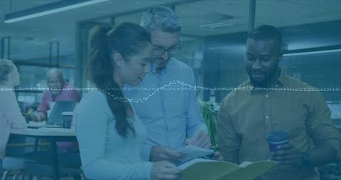 Office Team Collaborating Over Business Documents in Modern Workspace