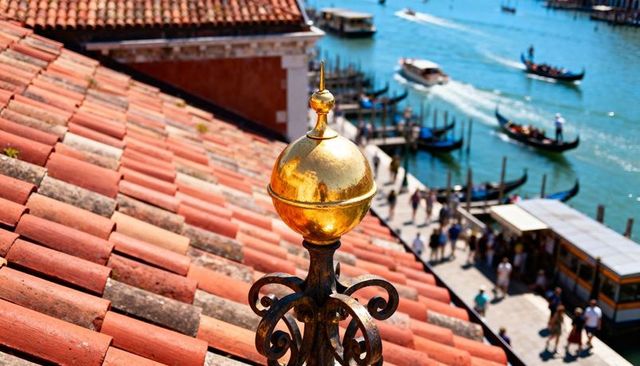 Gilded finial overlooking venetian canal with gondolas and terracotta roof