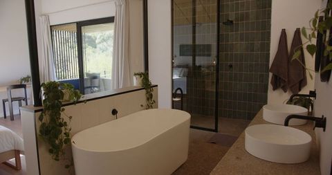 Modern bathroom with freestanding bathtub and balcony view