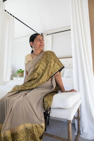 Elegantly dressed indian woman in serene room interiors