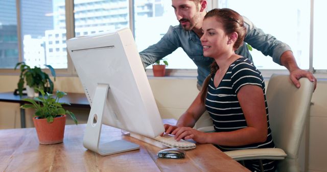 Office Colleagues Collaborating on a Desktop Computer in Bright Workspace - Download Free Stock Images Pikwizard.com