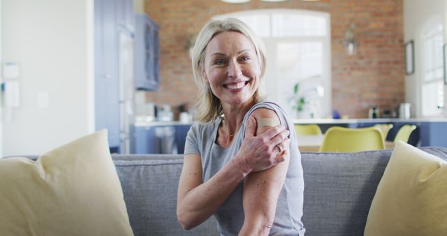 Happy Senior Woman Showing Bandage After Vaccination at Home - Download Free Stock Images Pikwizard.com