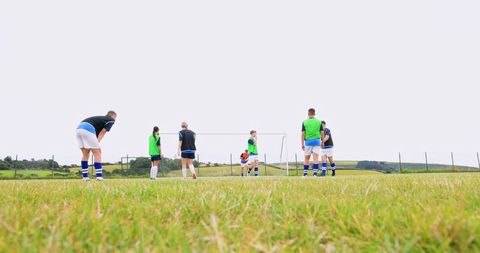 Soccer Team Training on Rural Field Emphasizes Teamwork