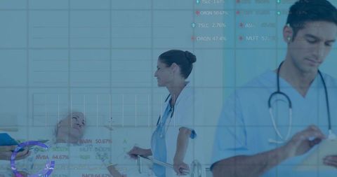 Clinician engaging patient at bedside with tablet and digital health data overlay