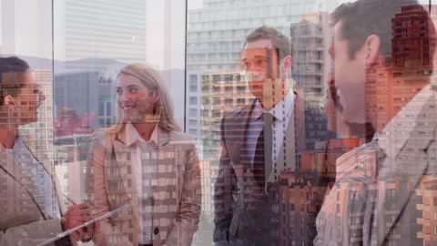 Happy Business Team Discussing Ideas Over Urban Skyline