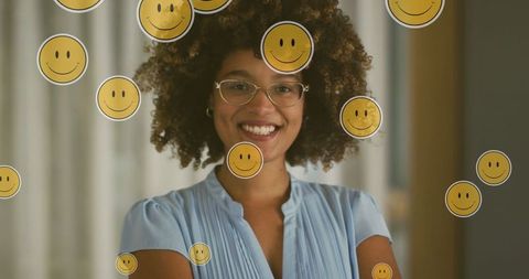 Confident woman smiling with overlay of emoji icons representing joy