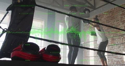 Boxers sparring in ring with red gloves and green data overlay, intense training