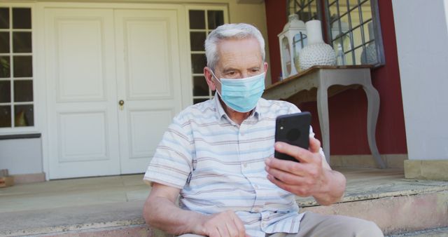 Senior Man Wearing Mask Using Smartphone on Porch - Download Free Stock Images Pikwizard.com