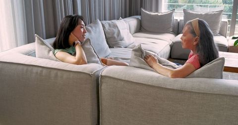 Mother and daughter enjoying quality time on cozy sofa