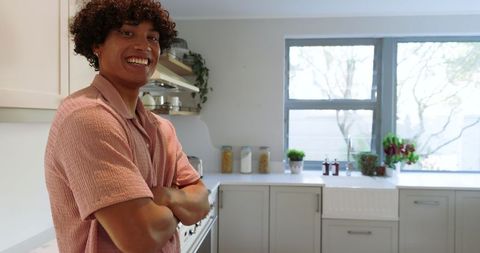 Cheerful Young Man in Modern Kitchen with Natural Light