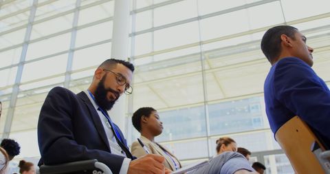 Diverse Professionals Attending Business Seminar with Focused Attention