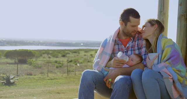 Family with Newborn Sharing Tender Moment Outdoors - Download Free Stock Images Pikwizard.com